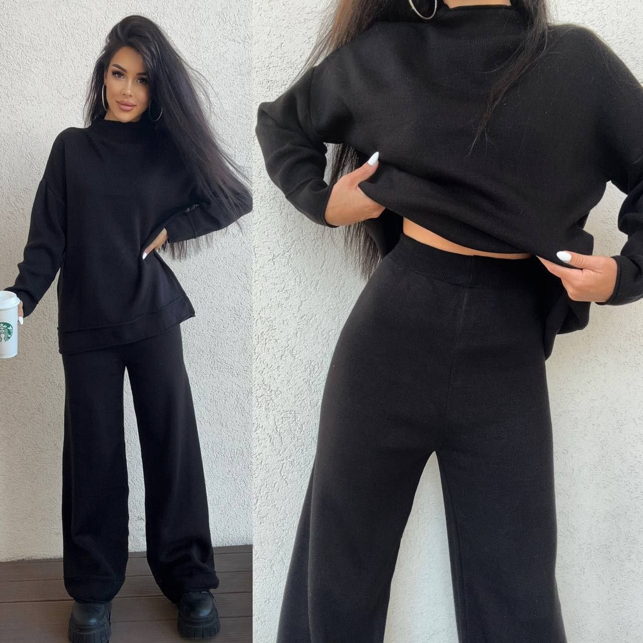 Person wearing a black outfit with a cropped hoodie and wide-leg pants, holding a Starbucks cup.