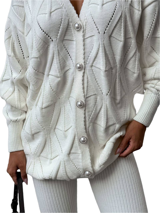 White knitted cardigan with pearl buttons on a white background