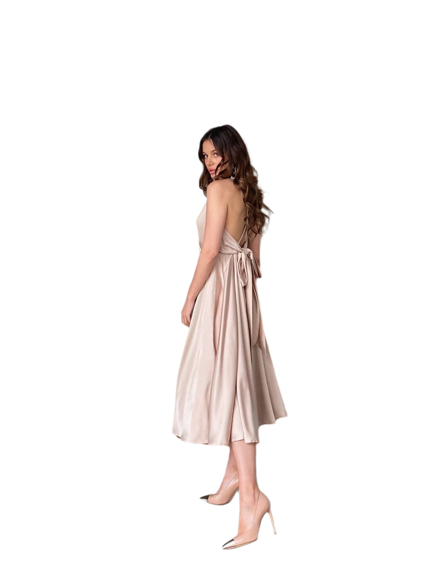 Woman wearing a beige dress with a backless design on a white background