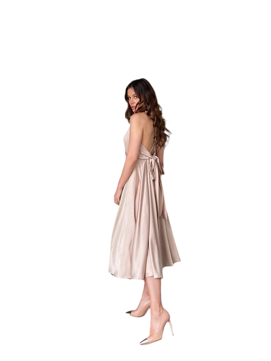 Woman wearing a beige dress with a backless design on a white background