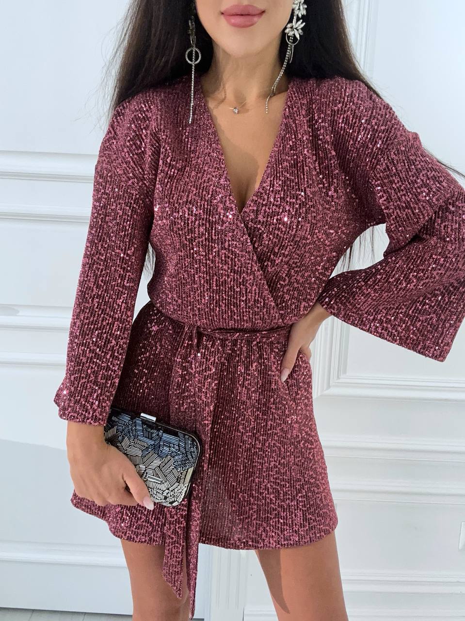 Woman wearing a burgundy textured dress with a white background