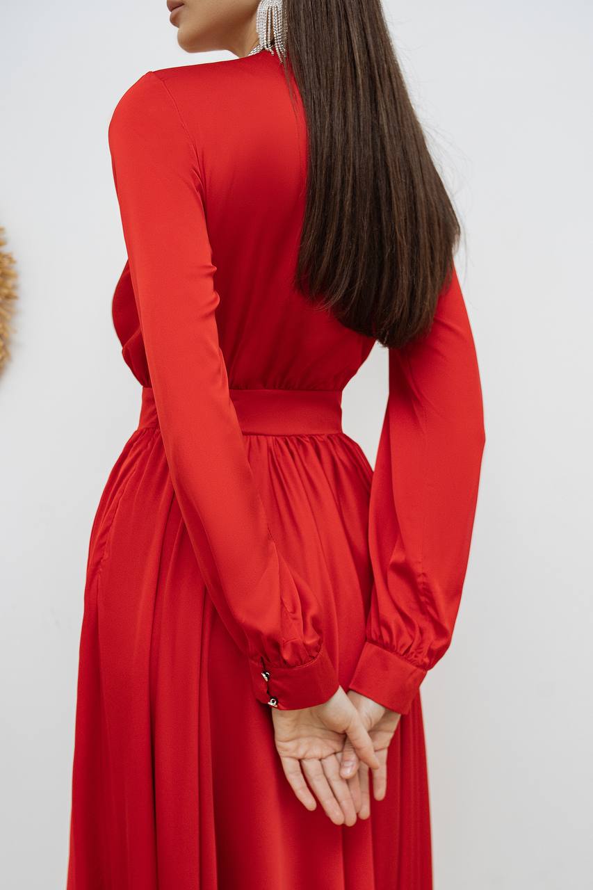 Red dress with long sleeves worn by a person on a white background