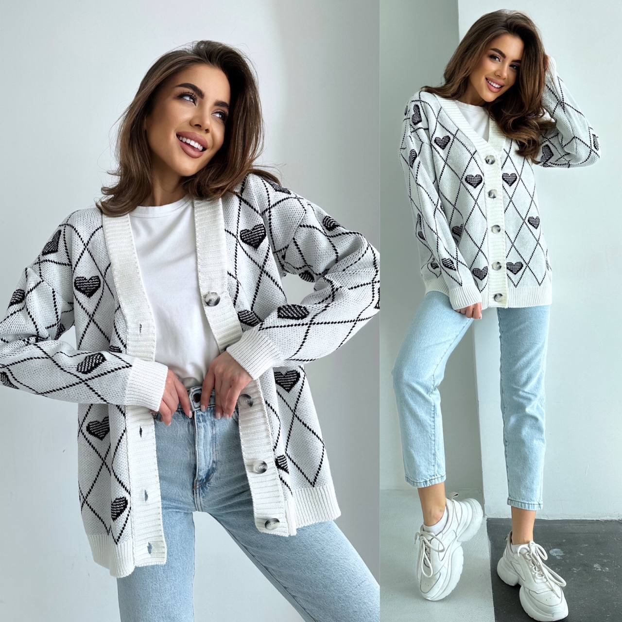 Woman wearing a white cardigan with black heart patterns, light blue jeans, and white sneakers.