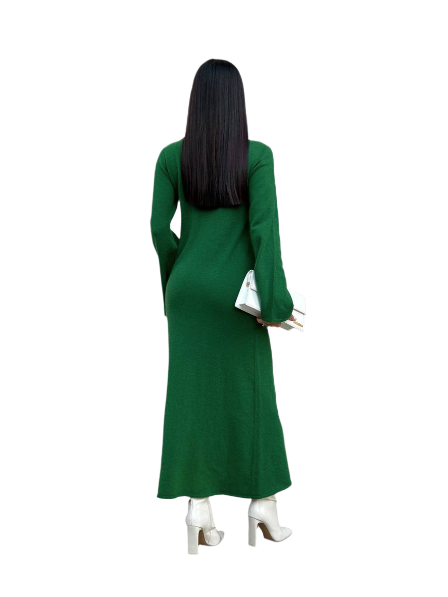 Person wearing a green dress with long sleeves on a white background