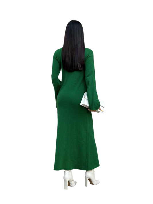 Person wearing a green dress with long sleeves on a white background