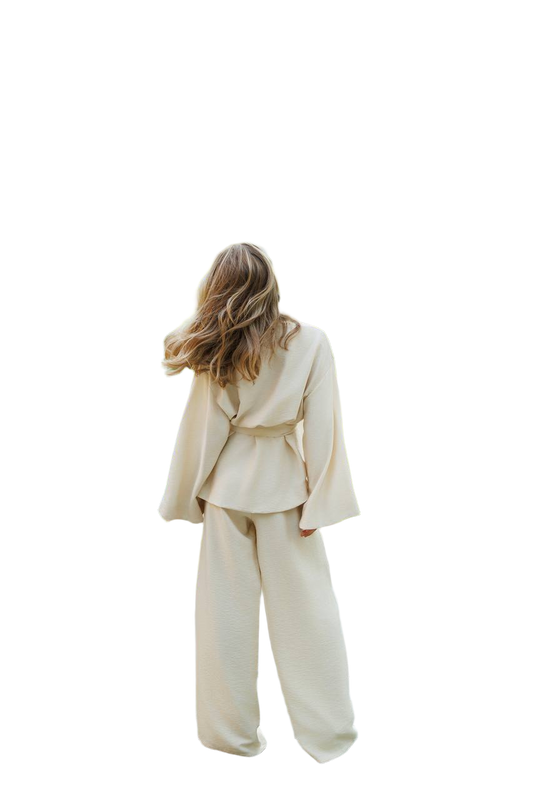 Person wearing a beige suit on a white background
