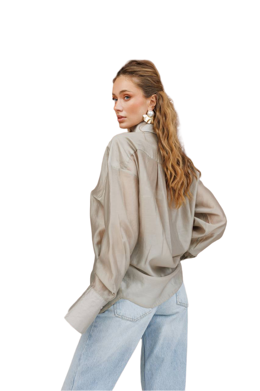 Woman wearing a beige blouse and light blue jeans on a white background