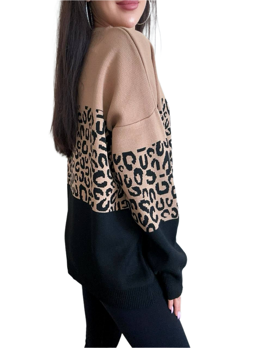 Person wearing a beige sweater with leopard print sleeves on a white background