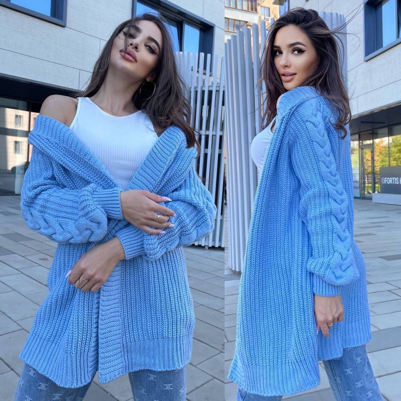 Woman wearing a blue knitted cardigan in an urban setting