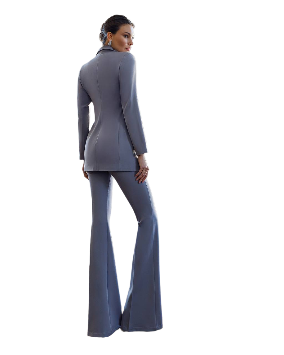 Woman wearing a gray suit with flared pants on a white background