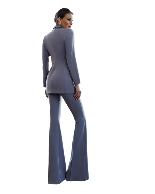 Woman wearing a gray suit with flared pants on a white background