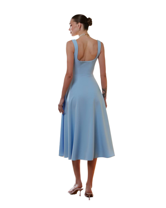 Woman wearing a light blue dress with an open back on a white background
