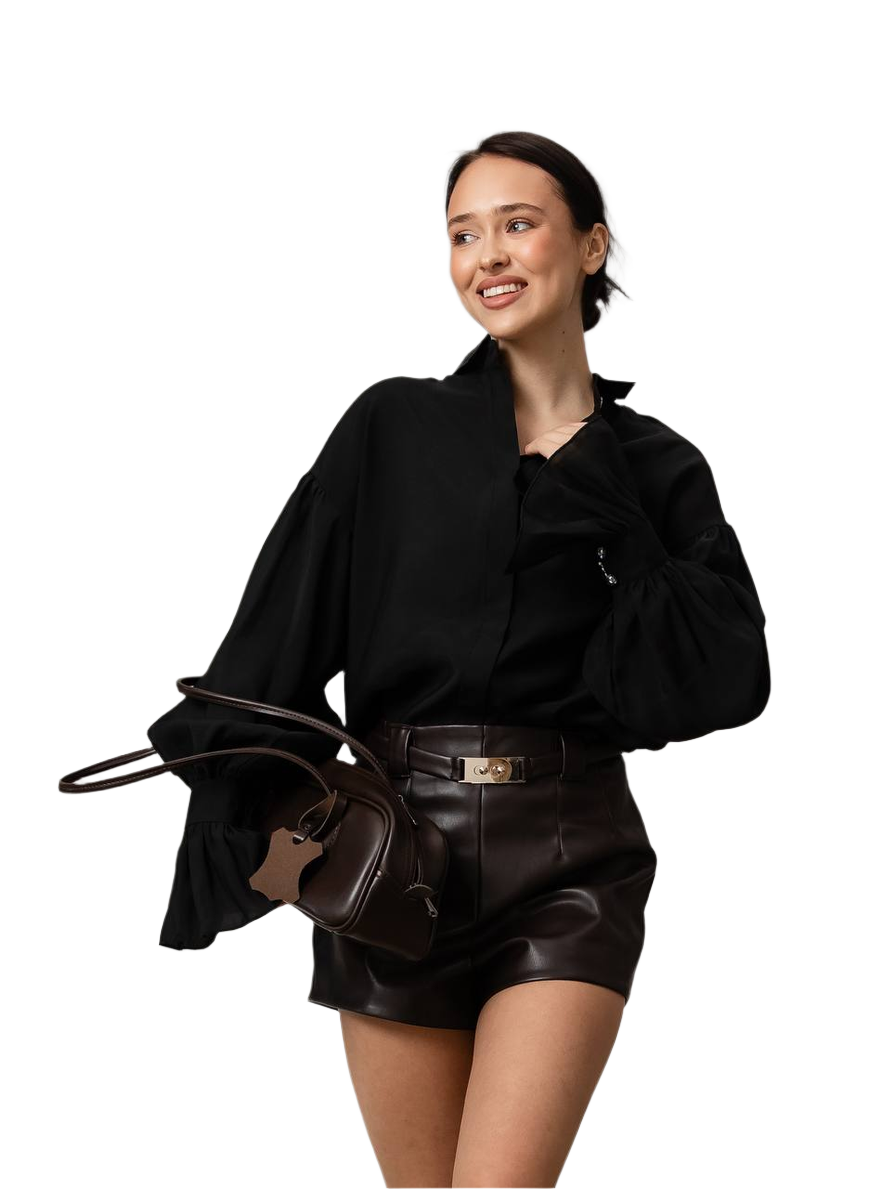 Woman wearing a black outfit with a leather handbag on a white background