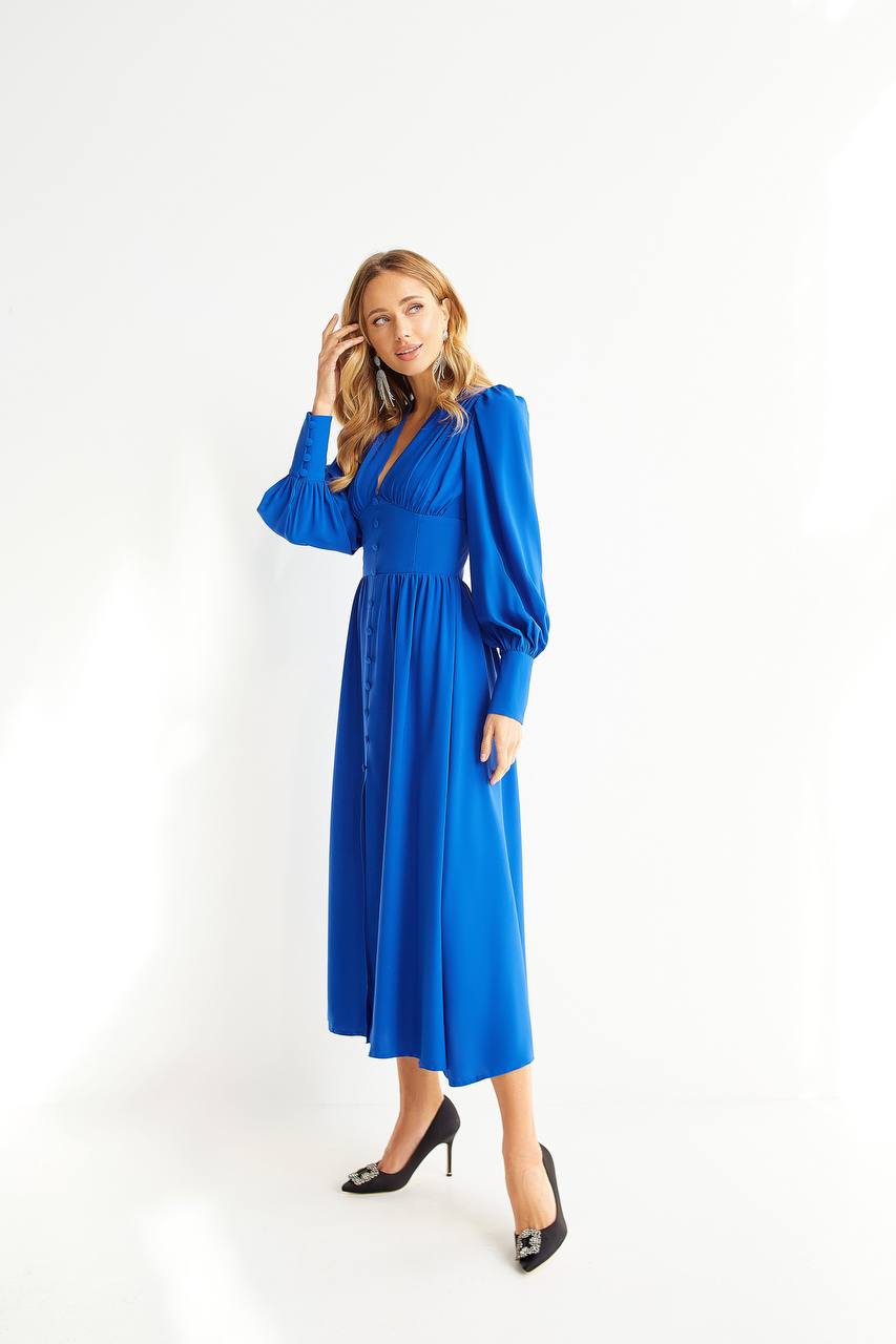 Woman wearing a blue dress on a white background