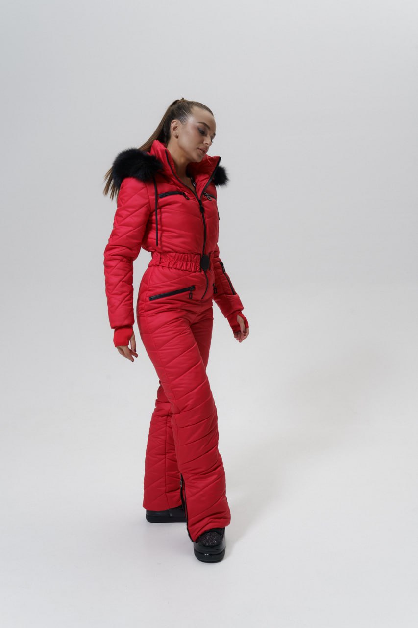 Person wearing a red snowsuit on a white background