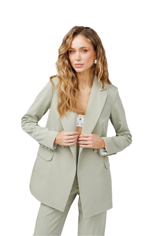 Woman wearing a light green suit on a white background