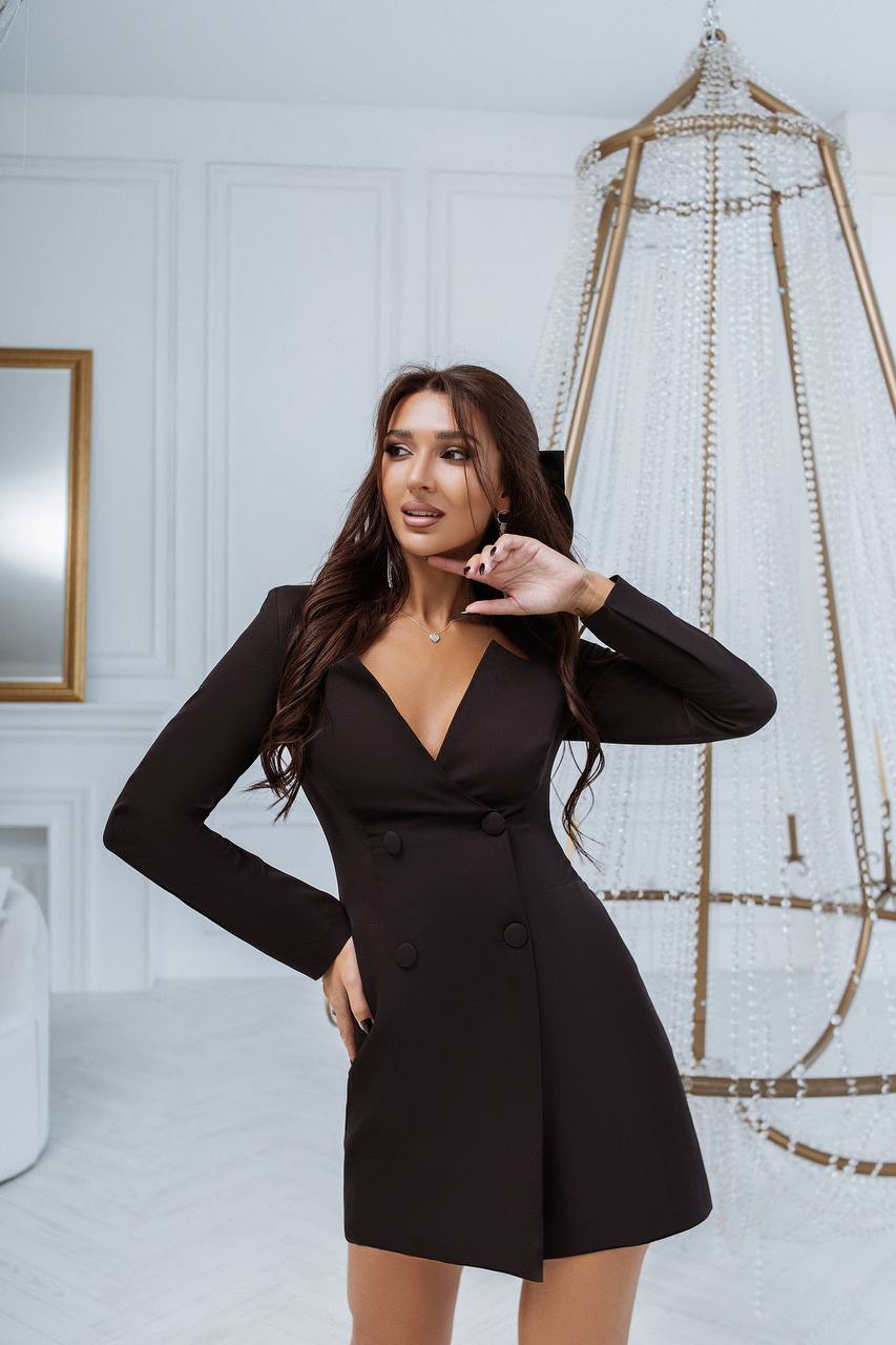 Woman wearing a black dress in an elegant interior setting