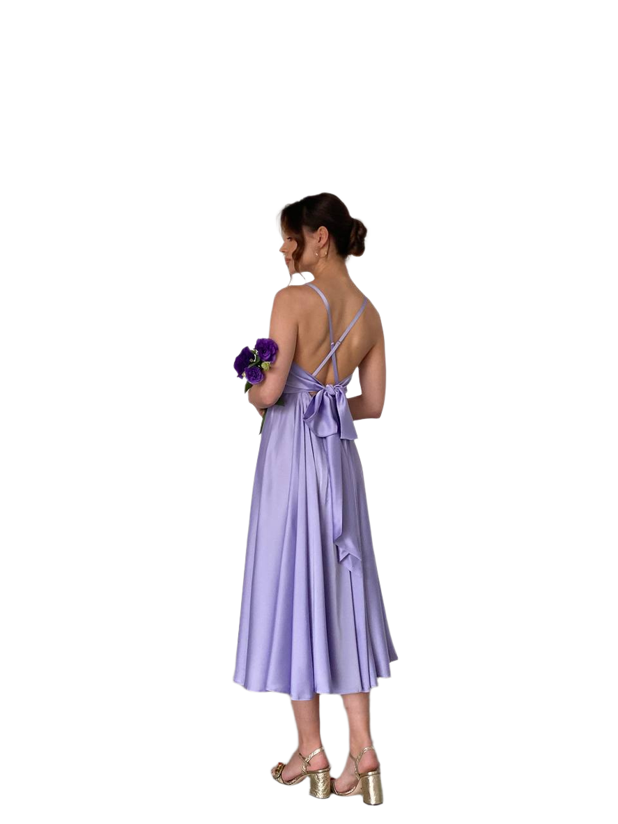 Woman wearing a purple dress holding flowers on a white background