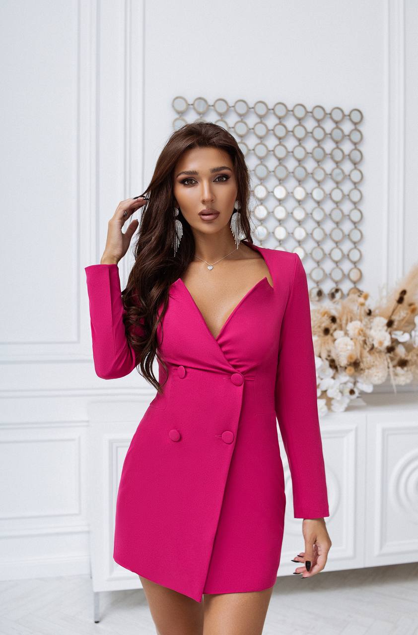 Woman wearing a bright pink dress in an elegant interior setting