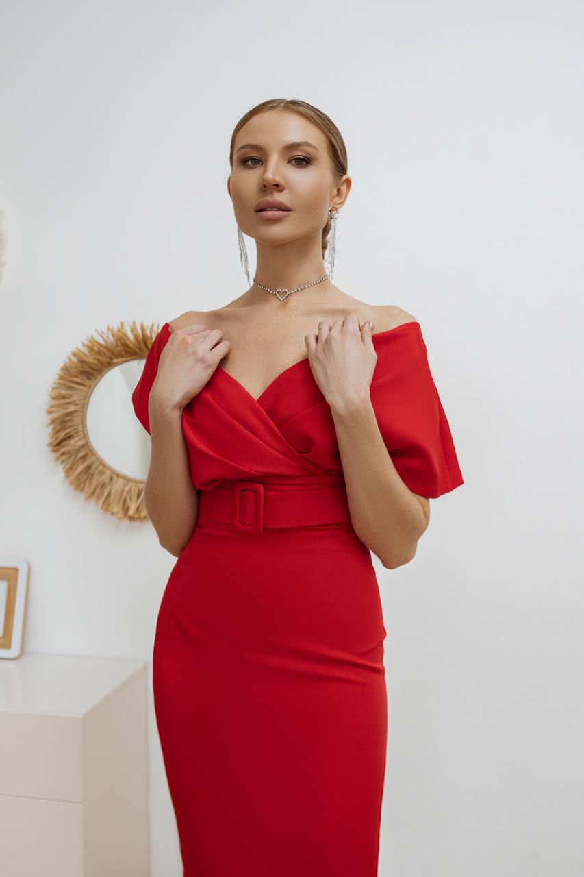 Woman wearing a red off-shoulder dress with a white background