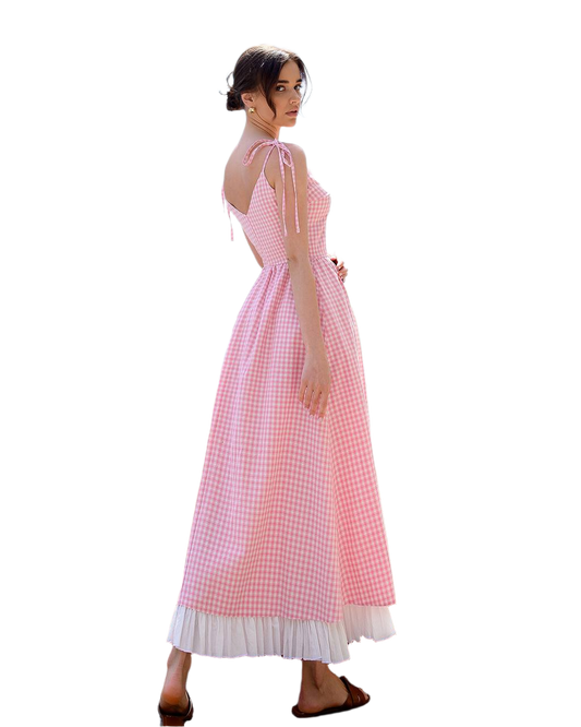 Woman wearing a pink checkered dress on a white background
