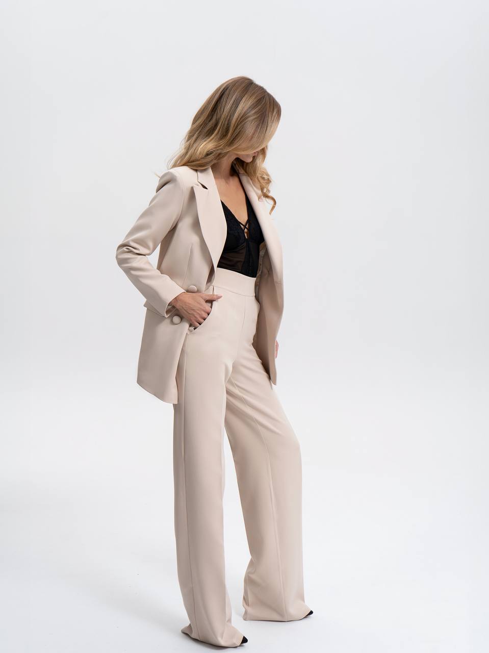 Woman wearing a beige suit on a white background