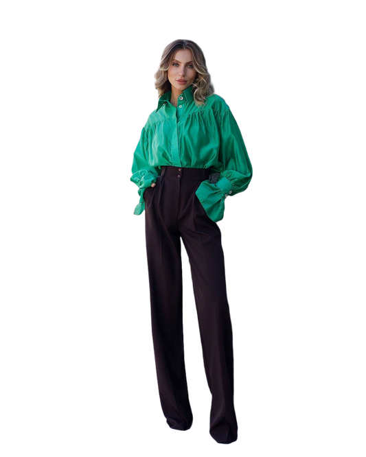 Woman wearing a green jacket and black pants on a white background