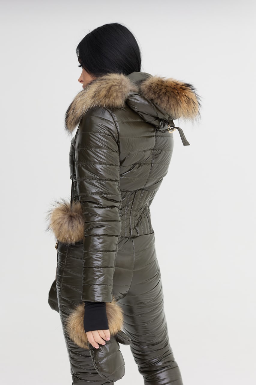 Person wearing a green puffer jacket with fur trim on a white background