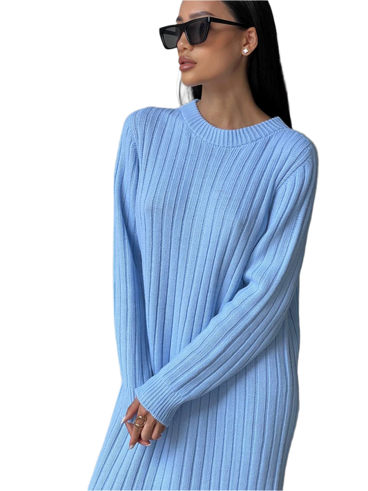 Woman wearing a light blue ribbed sweater dress on a white background