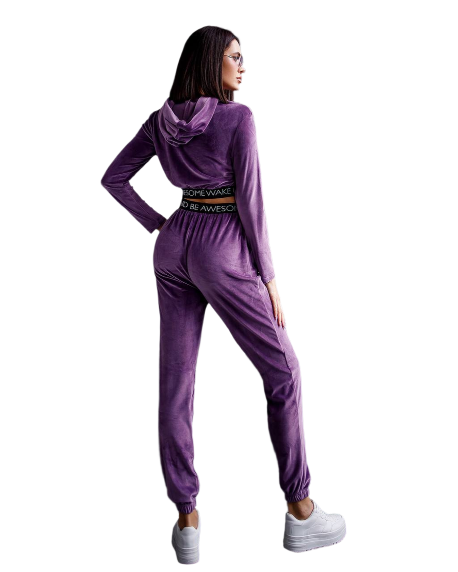 Purple tracksuit worn by a person on a white background
