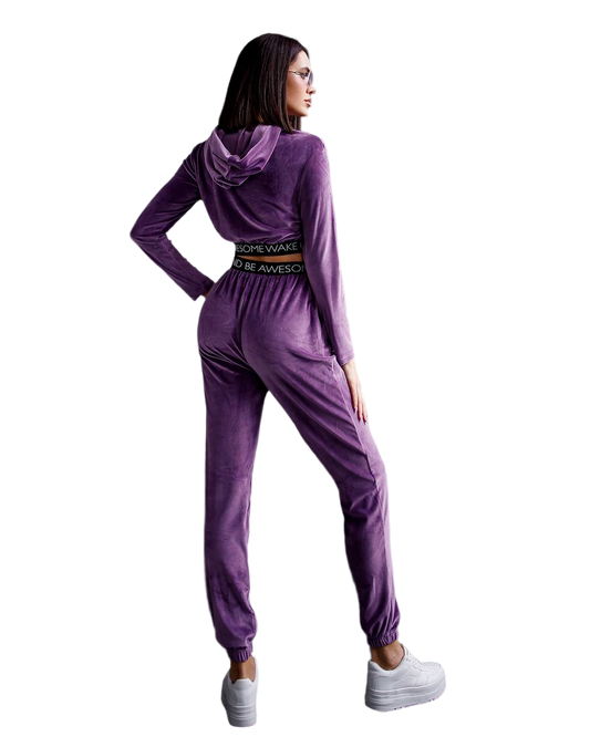 Purple tracksuit worn by a person on a white background