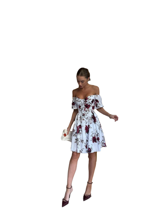 Woman wearing a floral off-shoulder dress on a white background