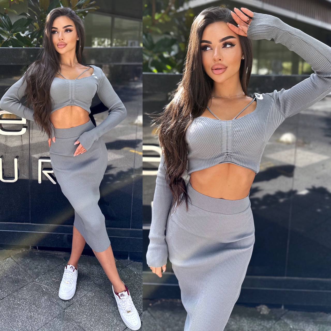Woman wearing a gray outfit with cut-out design in front of a building.