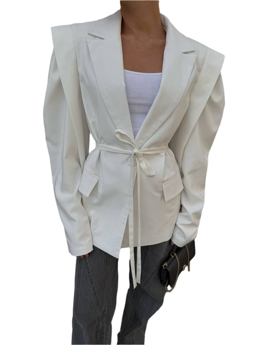White blazer with a belt tied around the waist on a white background