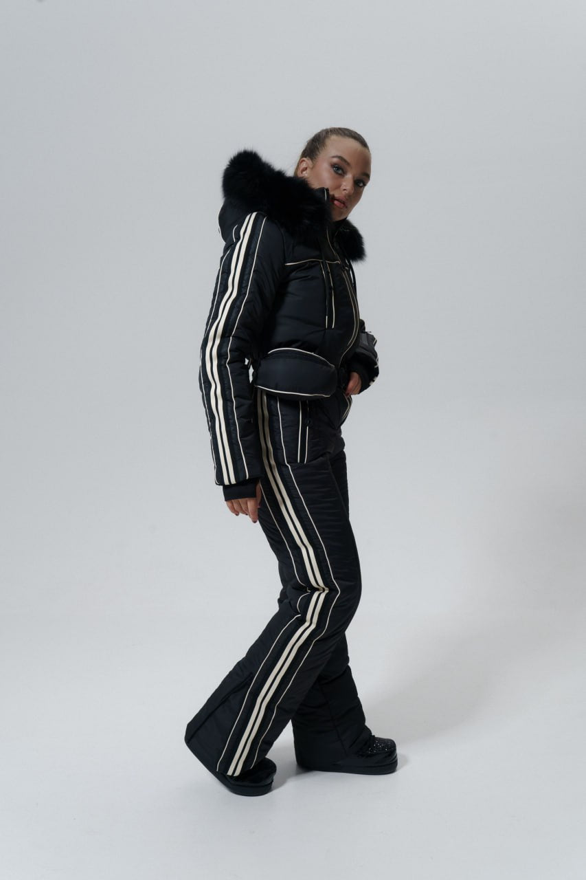 Person wearing a black outfit with white stripes on a white background