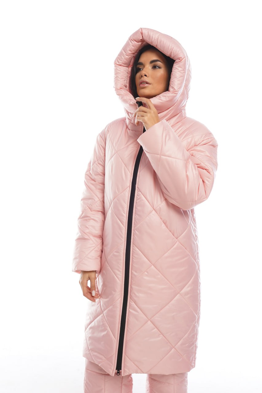 Woman wearing a pink quilted coat on a white background