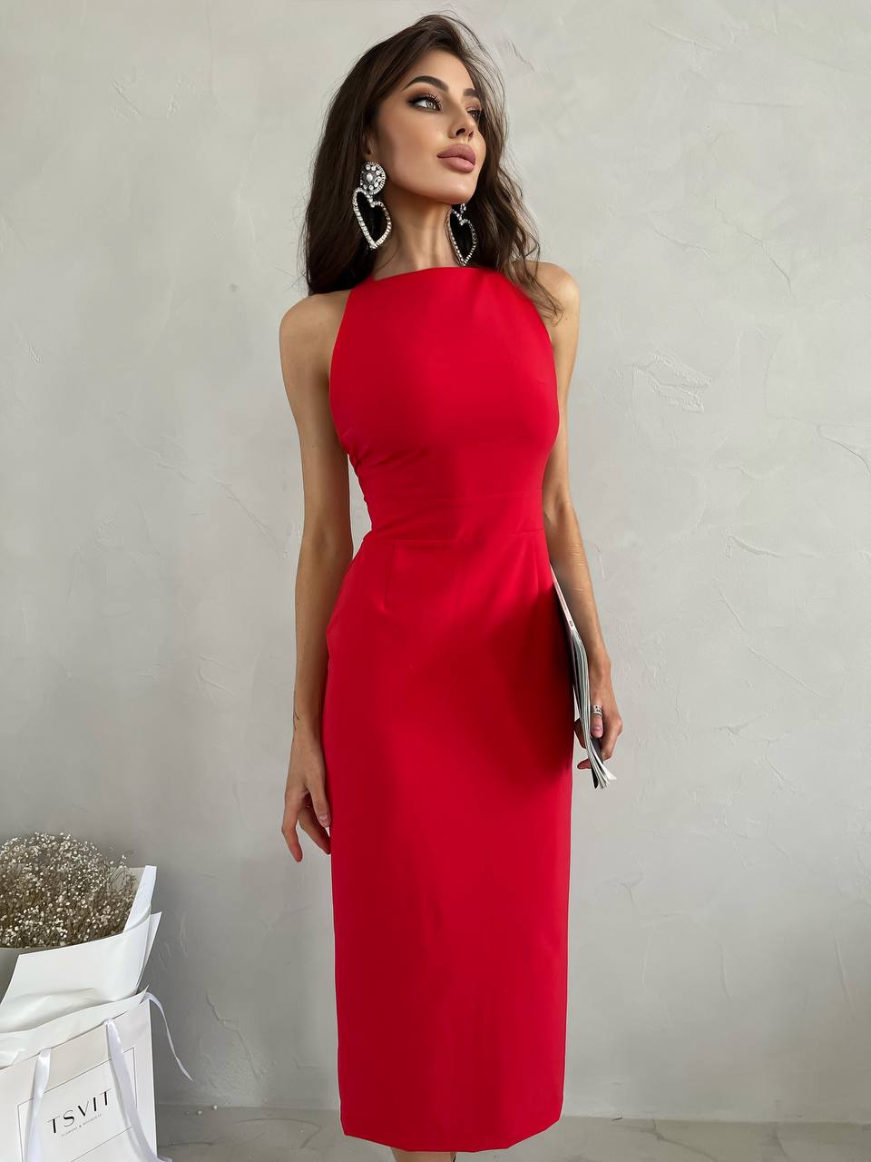 Woman wearing a red dress against a plain background