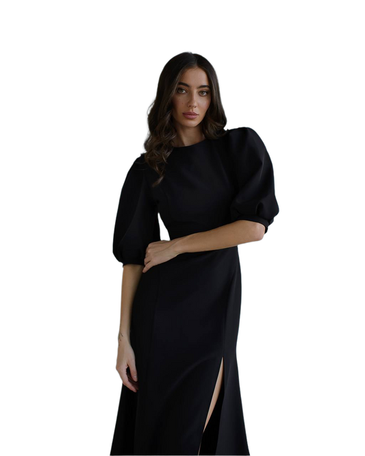 Woman wearing a black dress with puffed sleeves on a white background