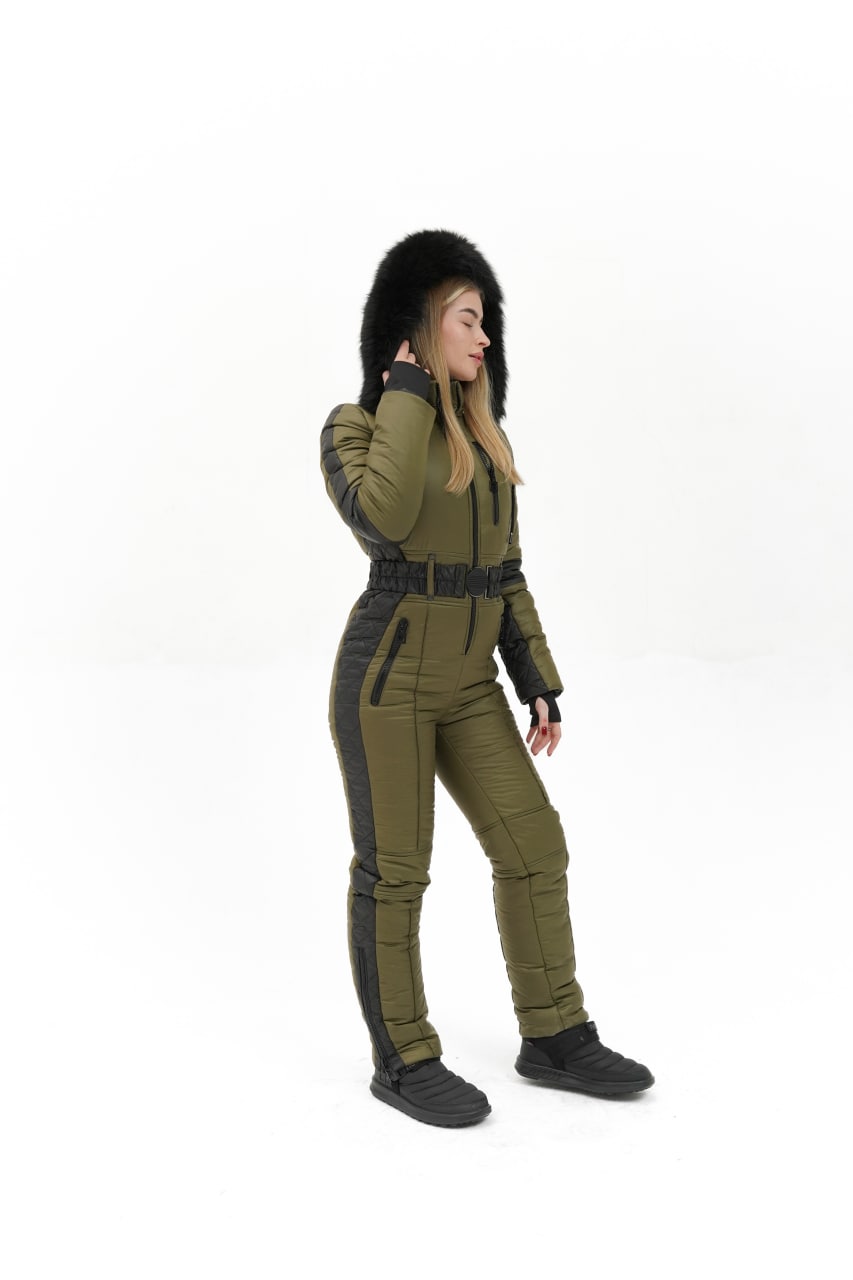 Person wearing a green and black jumpsuit on a white background
