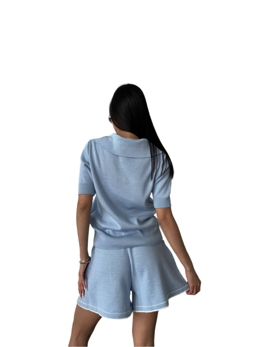 Woman wearing a light blue athletic outfit on a white background