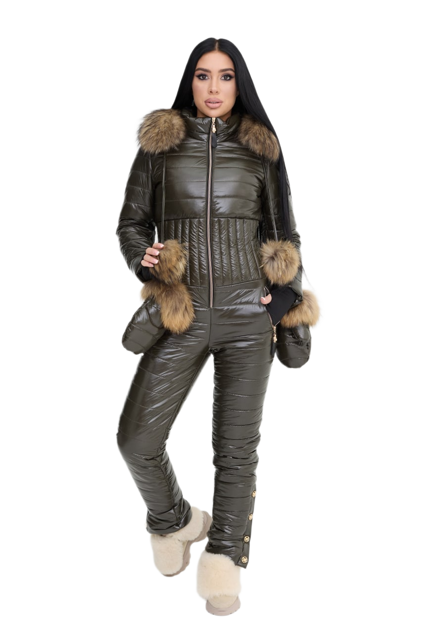 Woman wearing a dark green puffer jumpsuit with fur trim on a white background