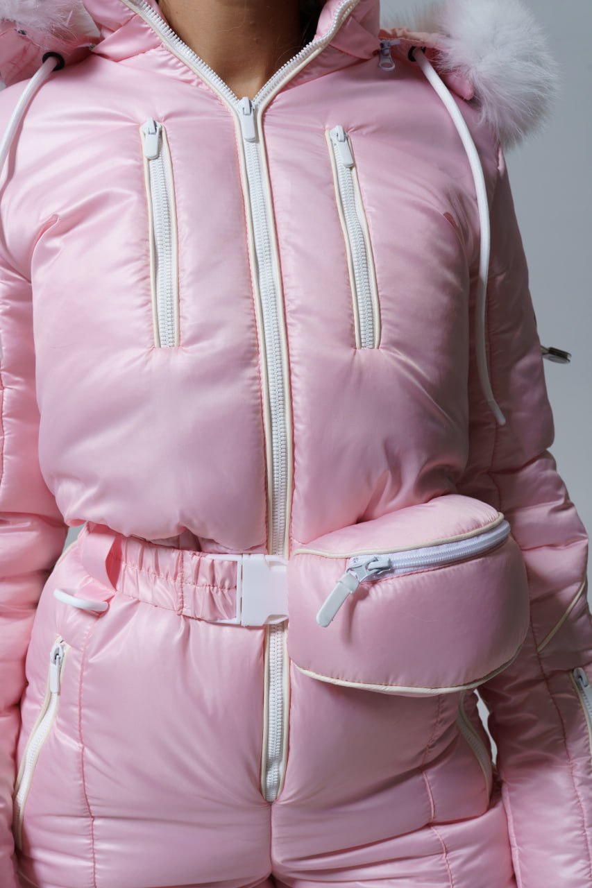 Pink winter jacket with fur hood on a gray background