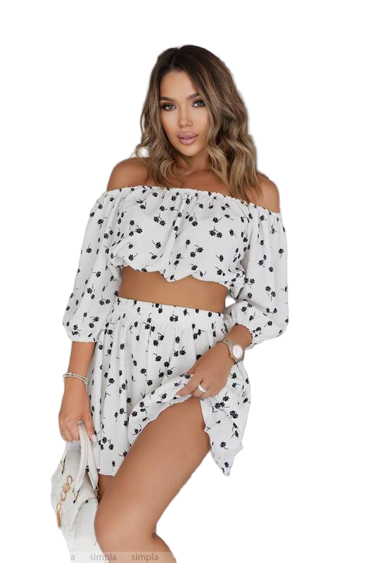 Woman wearing a white off-shoulder top with black polka dots on a white background