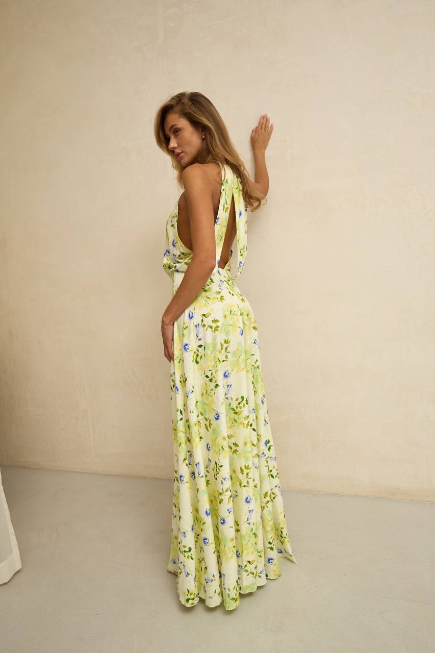 Woman wearing a floral dress against a beige background