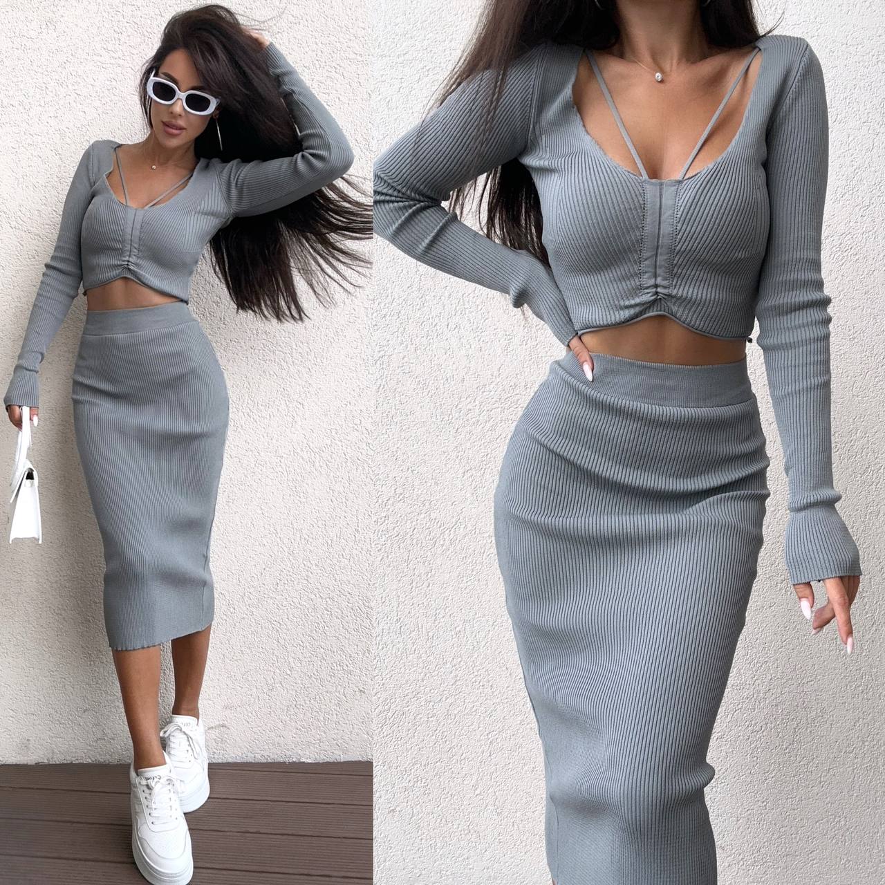 Woman wearing a gray long-sleeve top and skirt set against a white background