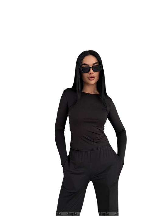 Woman wearing a black outfit with sunglasses on a white background