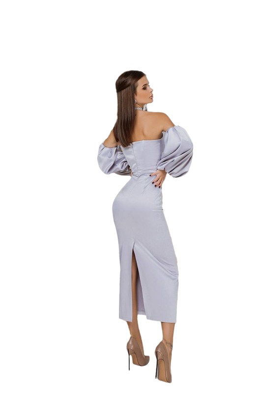 Woman wearing a light gray off-shoulder dress with a high slit on a white background