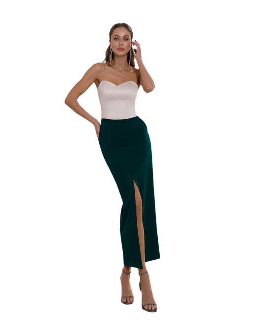 Woman wearing a strapless top and green skirt on a white background