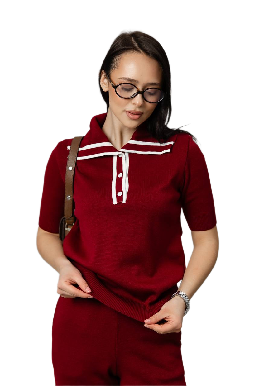 Woman wearing a red outfit with white accents on a white background