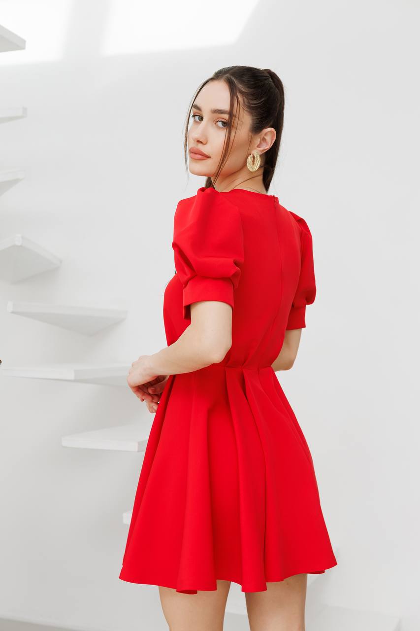 Woman wearing a red dress against a white background